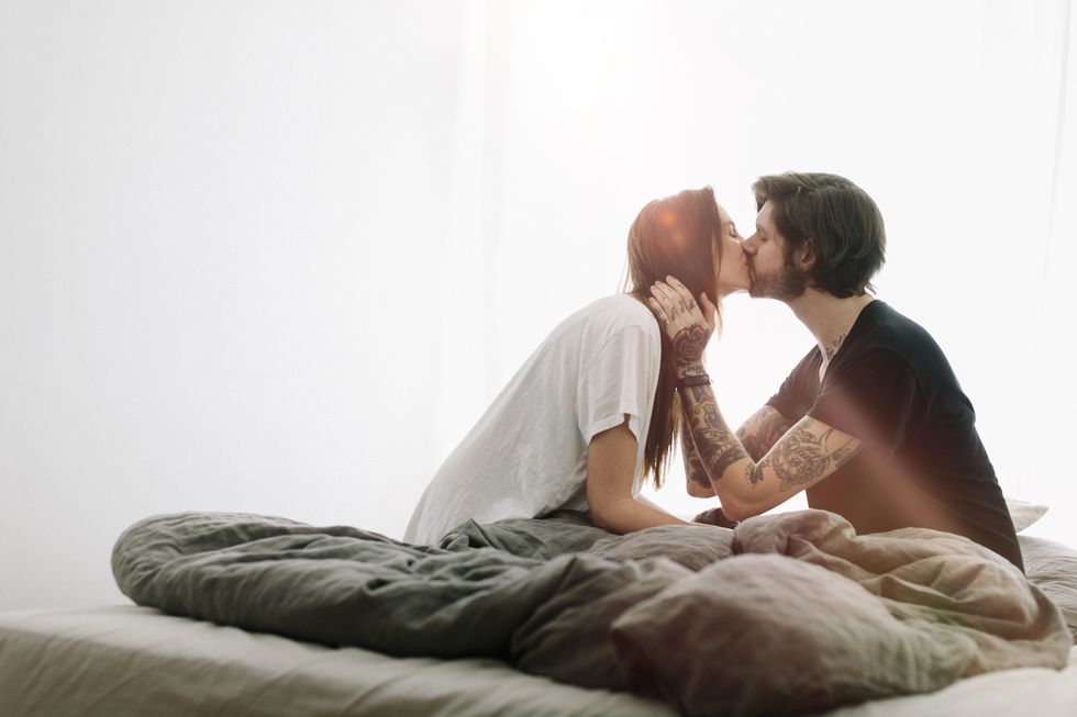 young-couple-kissing-in-bed-royalty-free-image-1580811065.jpg